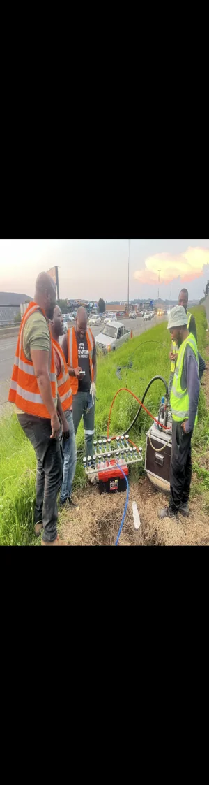 Technician performing a fusion splice on fibre-optic cable in a joint closure